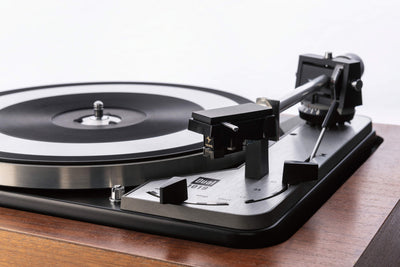 turntable with black vinyl record and silver tonearm showcasing a classic design for vinyl enthusiasts