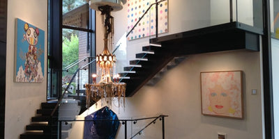 Collector Amy Phelan standing by a standout staircase in her Aspen home