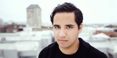 Carlos Rivera art rank interview promotional image with artist portrait and colorful abstract background