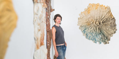 Brie Ruais artist interview portrait with abstract colorful artwork background
