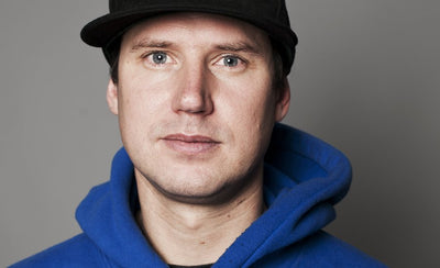 Skateistan Oliver Percovich interview banner image with skateboard and urban background