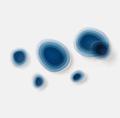 blue decorative glass wall art in various oval shapes