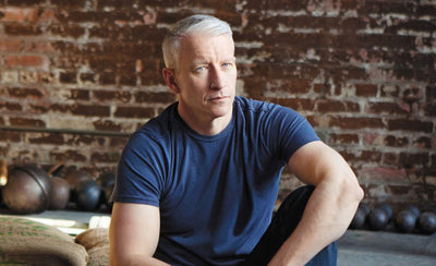 anderson cooper portrait with art pieces background colorful paintings