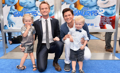 Neil Patrick Harris posing with artwork from his private collection featuring contemporary artists