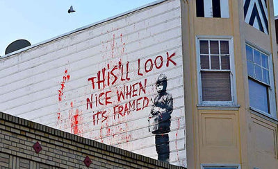 Banksy artwork street art graffiti stencil on wall with money theme