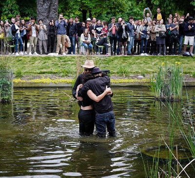 jr arcade fire band performing live on stage with vibrant lighting and enthusiastic crowd in background