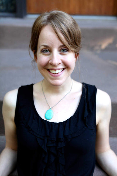 Leah Singer performing live with guitar and microphone on stage