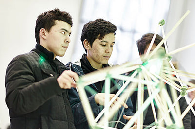 close-up of a person holding a vintage camera with a blurred background