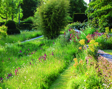 Great Dixter House and Garden: Meadows, Northiam, East Sussex, England. Designers: original layout by Edwin Lutyens, planting by Daisy Lloyd, Christopher Lloyd and Fergus Garrett. Photography by Claire Takacs