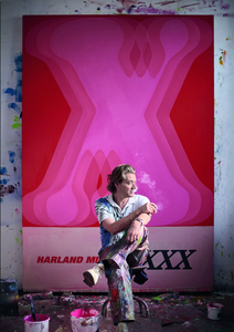Harland Miller in front of the original painting from which the XXX, 2023 edition is sourced. Courtesy White Cube; photo Ollie Hammick