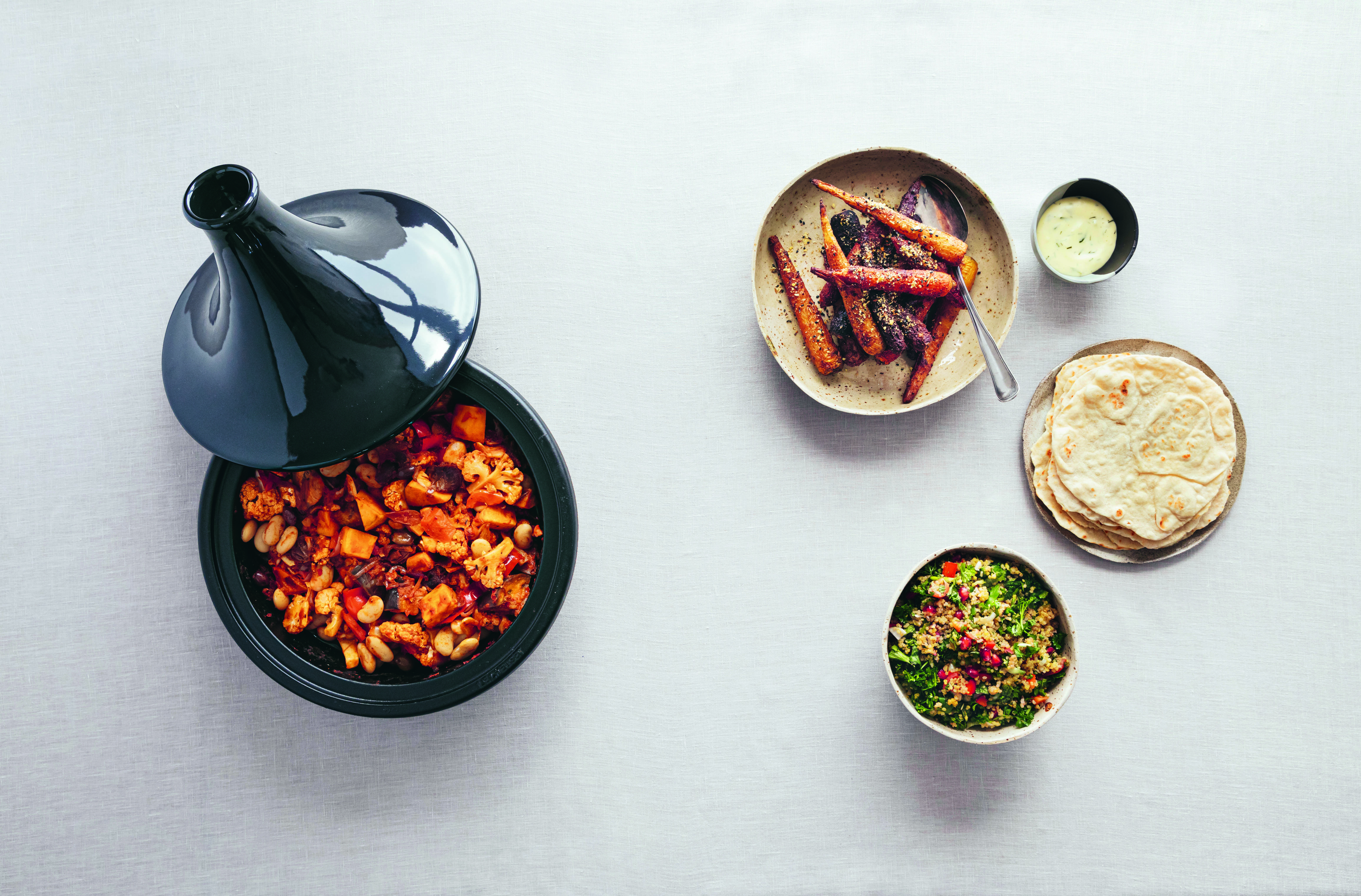 Vegetable Tagine, Tzatiki, Flatbread, Herbed Quinoa, Spicy Roasted Carrots with Black Gomasio. Photography by Hildur Ársælsdóttir