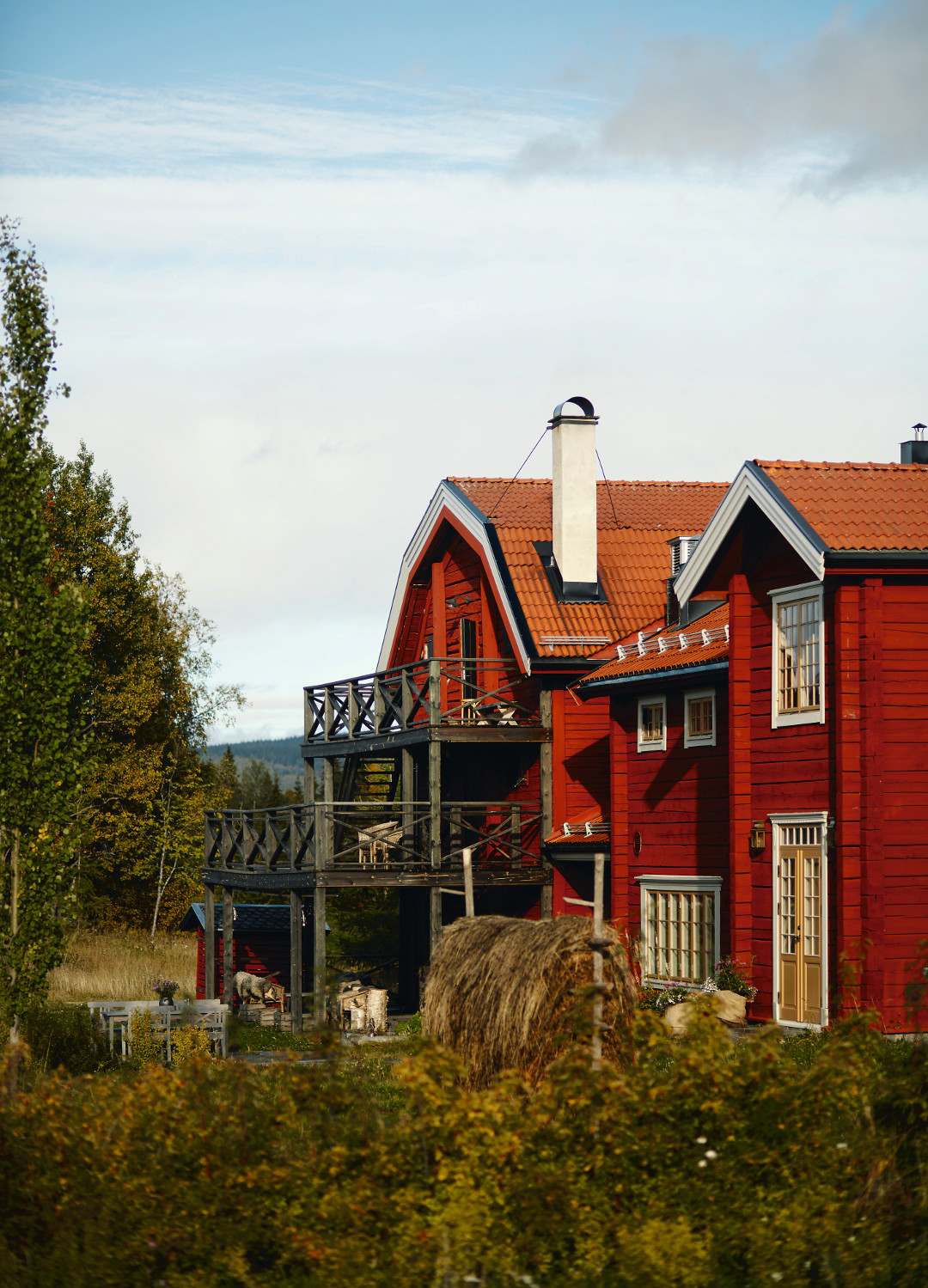 The restaurant in late summer with hay drying in the wind on a traditional hay fence