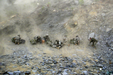 Nuristan, Afghanistan, 2007. A helicopter comes to land on an impromptu helipad built into the side of the mountain at the outpost of Aranas