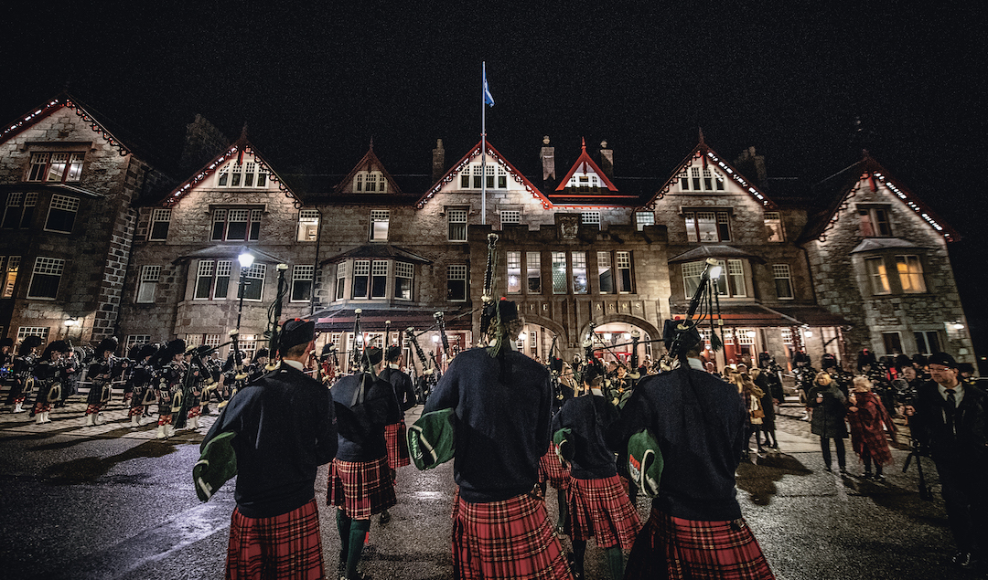 Pipers beside The Fife Arms. Photograph by Sim Canetty-Clarke