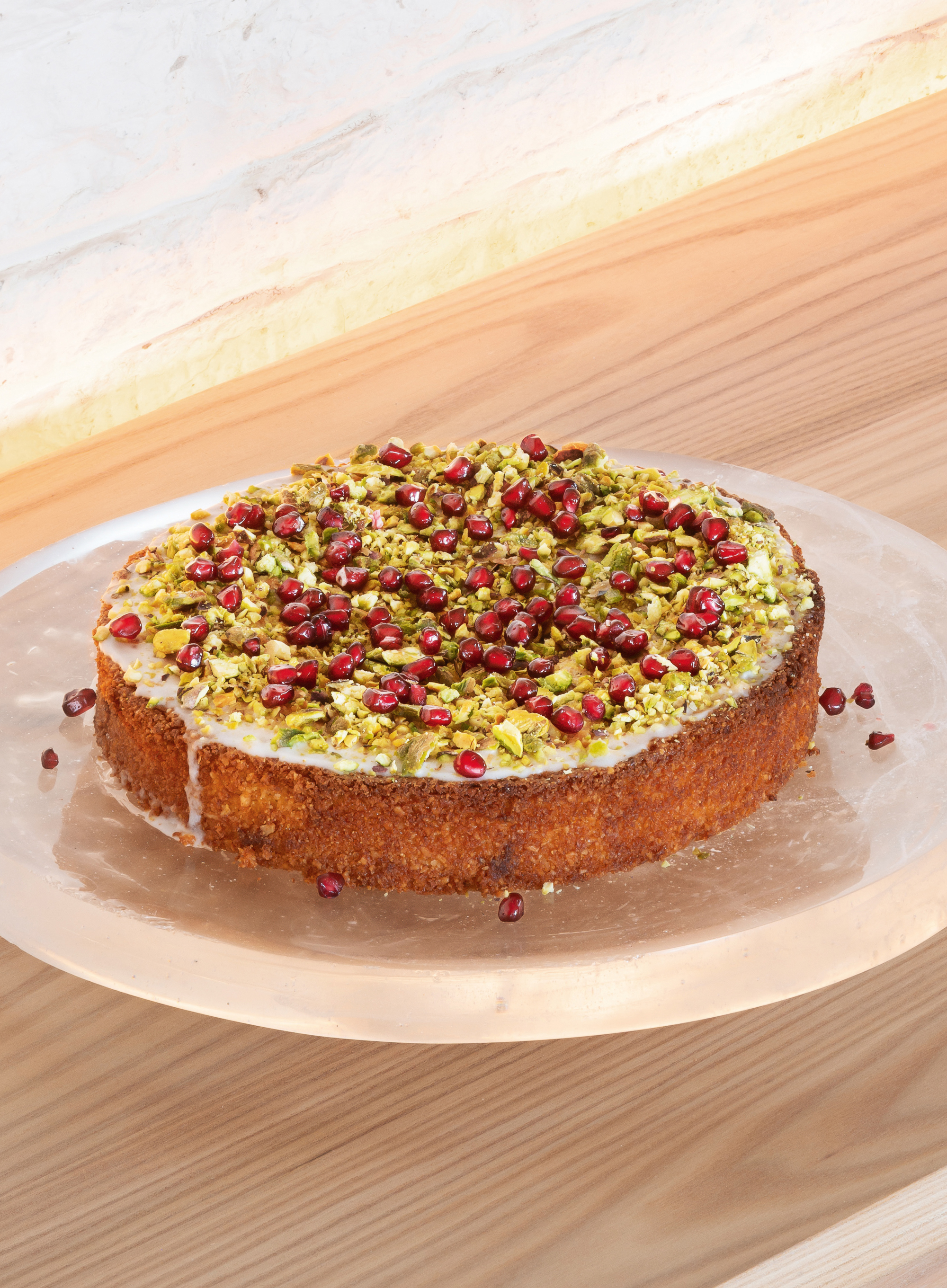 Lemon and almond cake with pomegranates and pistachios. Photograph by Gilbert McCarragher