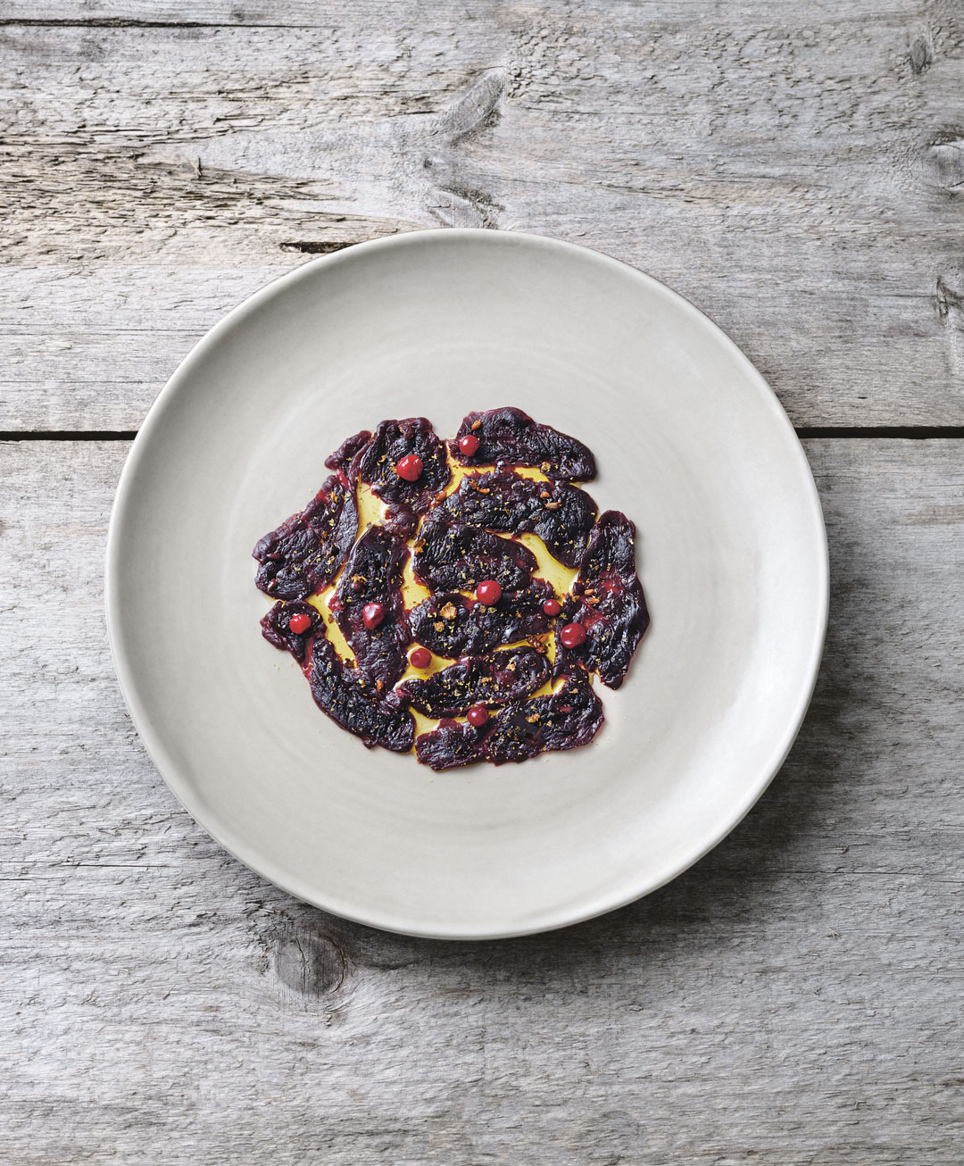 Seal carpaccio, alder, juniper and partridgeberries. Photograph by John Cullen. From Wildness