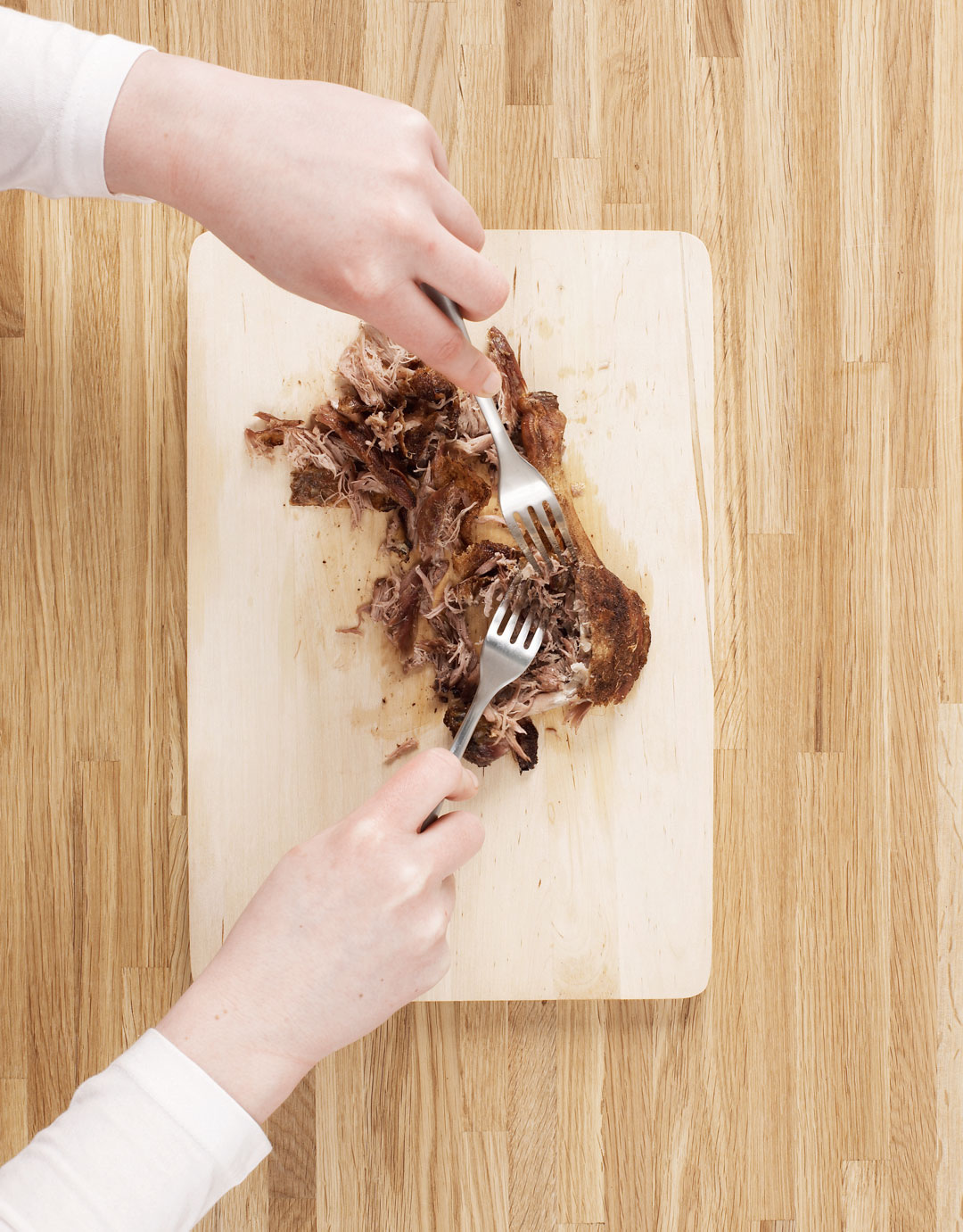 Shredding the duck meat, as part of Jane Hornby's crispy duck pancakes