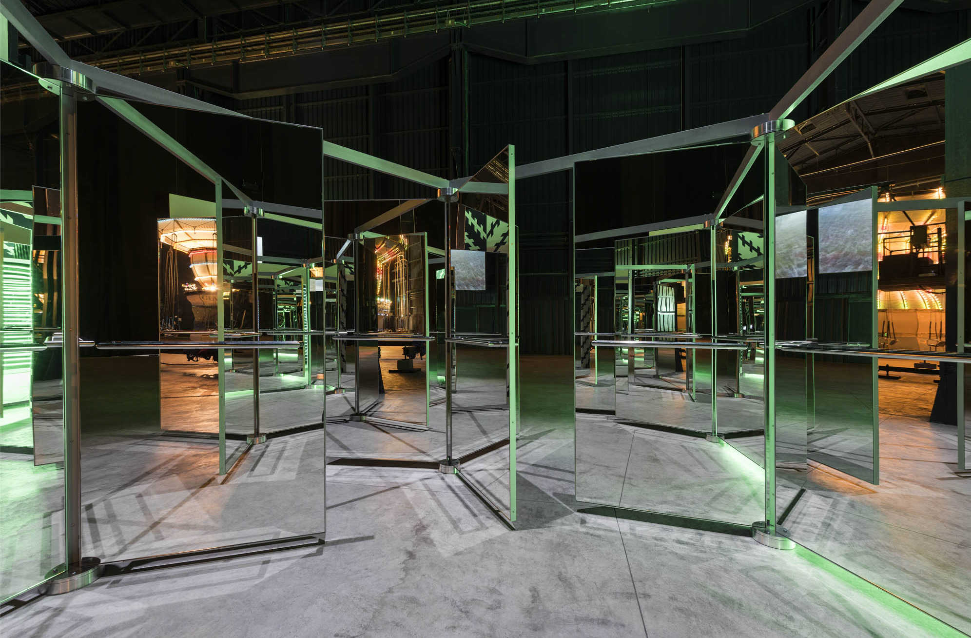 Carsten Höller Revolving Doors, 2016, mirrored revolving glass doors, aluminum, alucobond, steel 219 3/4 × 219 3/4 × 89 3/4 inches (558 × 558 × 228 cm) Artwork © Carsten Höller. Photo by Attilio Maranzano. Courtesy Hayward, Hangar Bicocca and Gagosian.