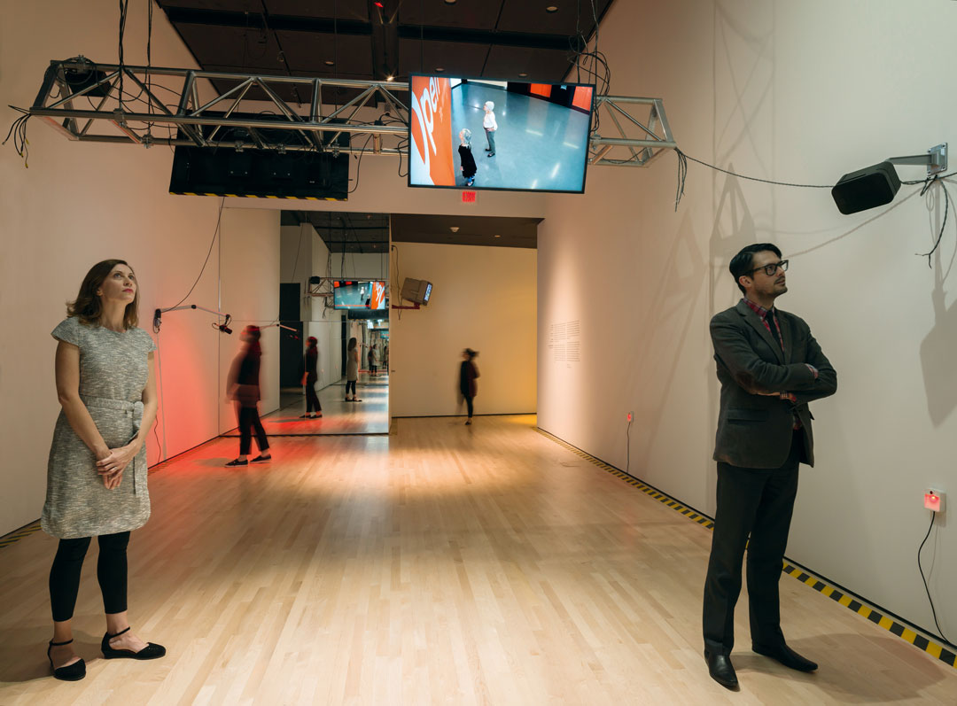 Julia Scher, Predictive Engineering, 1993–present Multichannel video and sound installation, with live cameras, sensors, microphone, mirrors, tape, plastic balls, drone, and text-messaging service; dimensions variable. Installation view: San Francisco Museum of Modern Art