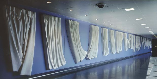 Curtain Wall (2001) 600' linear relief sculpture, modified gypsum, pictured on site - John F. Kennedy International Airport, International Air Terminal, Terminal 4. Image courtesy of Will Faller.