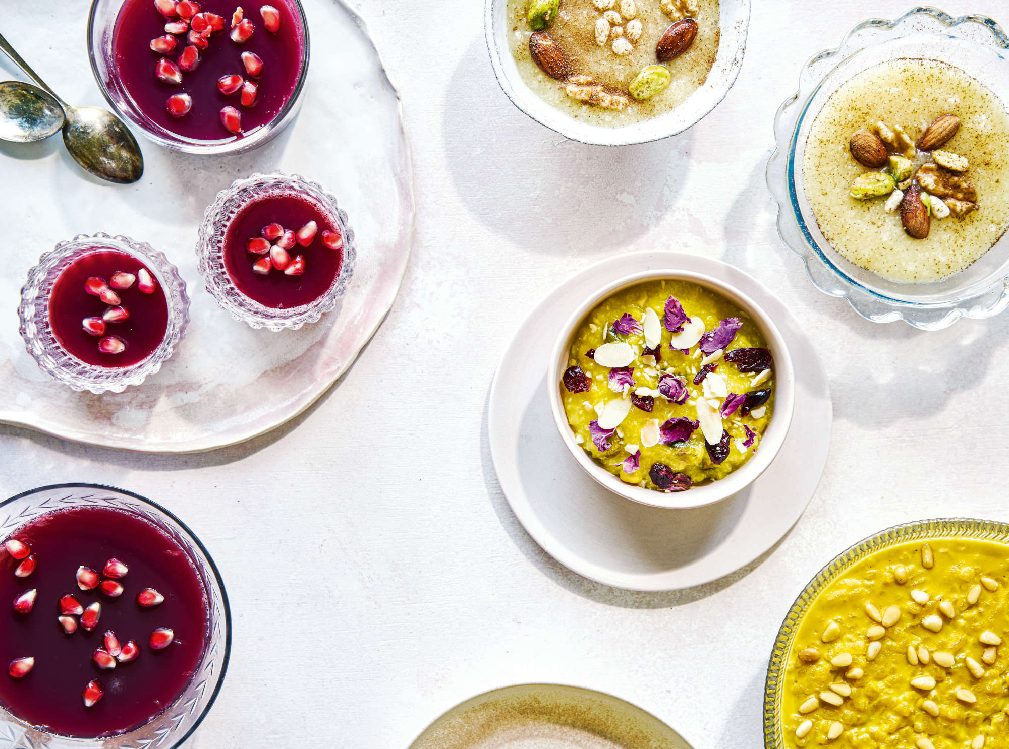 Pomegranate Jellies, Spiced Rice Pudding, Tahini Rice Pudding, Persian Saffron Rice Pudding ((Shole Zard) (clockwise from top left). Photography: Liz and Max Haarala Hamilton