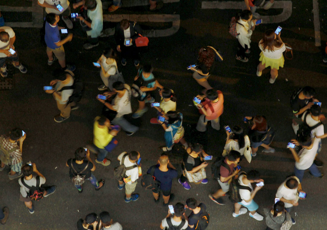 Fans of Nintendo’s Pokémon Go, a location-based augmented reality game, cause a traffic jam at a PokéStop, a physical space where gameplay occurs.
Picture by Liau Chung Ren