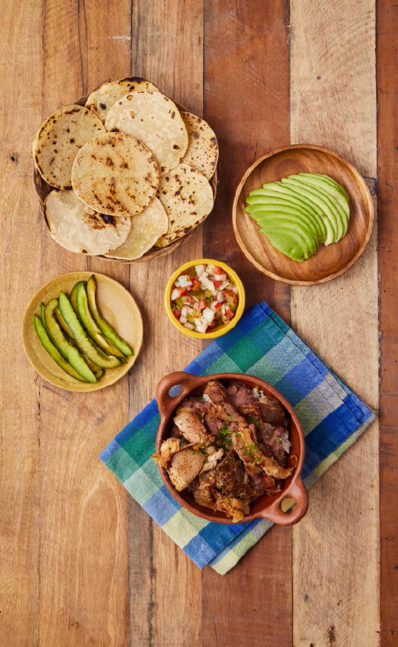 Crispy pork, rice, and beans, served with fresh corn tortillas