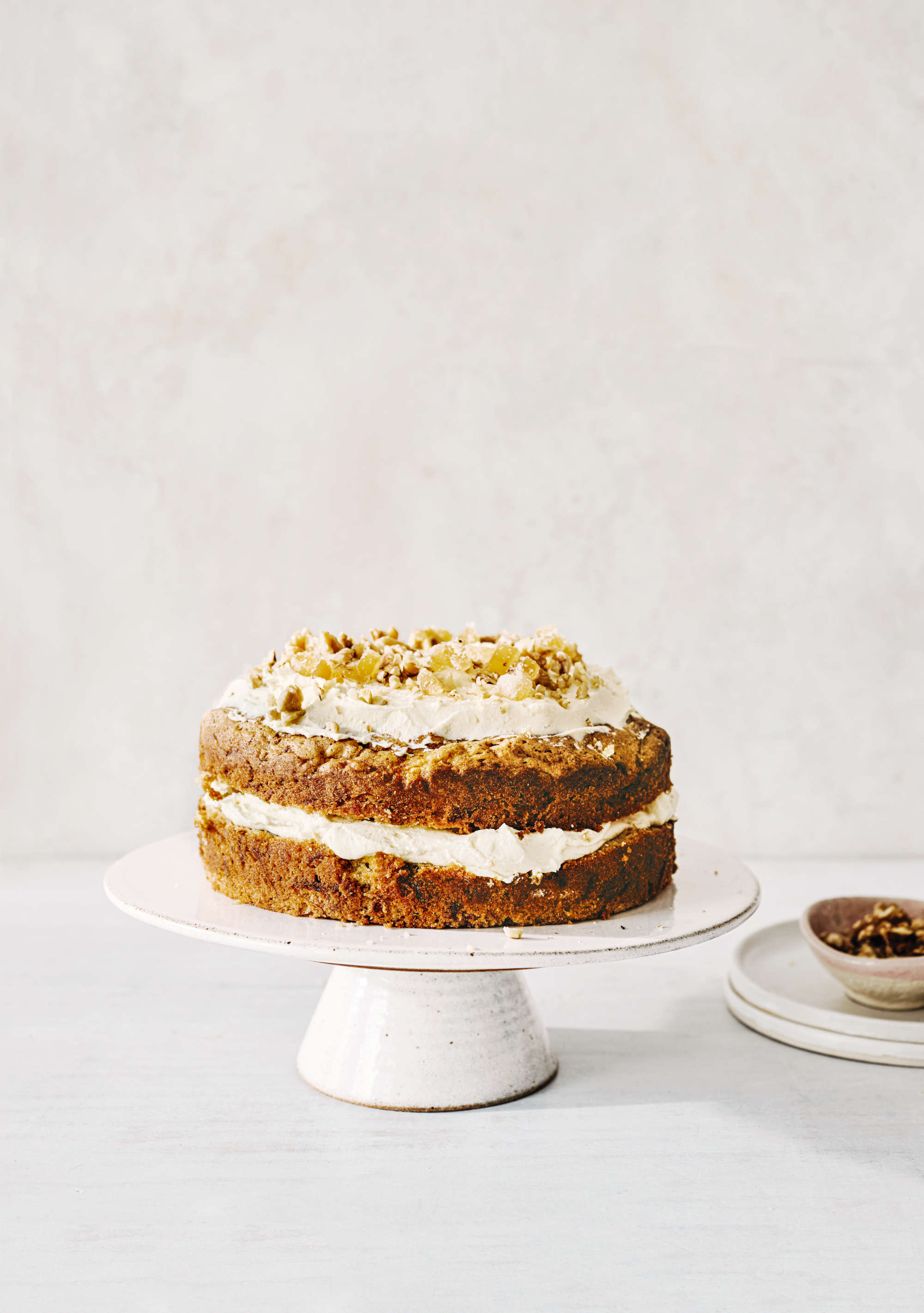 Butter and cream cheese frosting tops this carrot, walnut and candied ginger cake