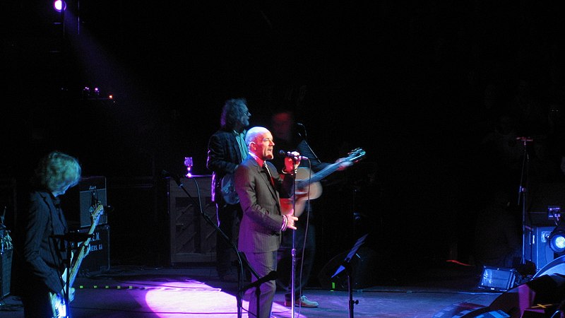 Michael Stipe (centre) performing with R.E.M. in 2008. Photograph by Wonker, courtesy of Wikimedia Commons