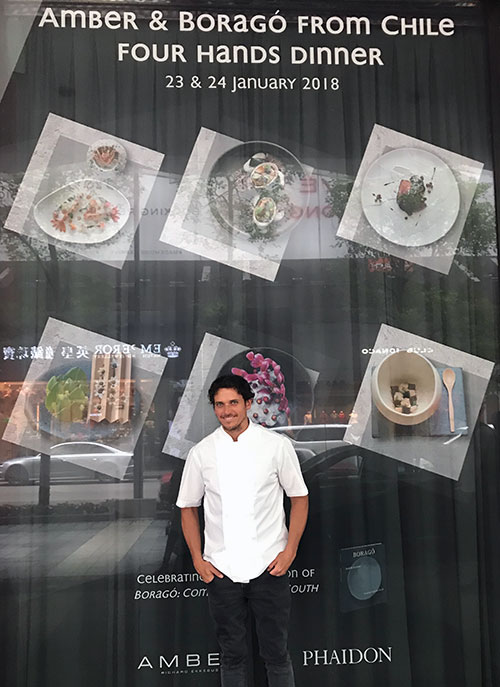 Rodolfo Guzmán beside the Amber window advertising his dinner with Richard Ekkebus