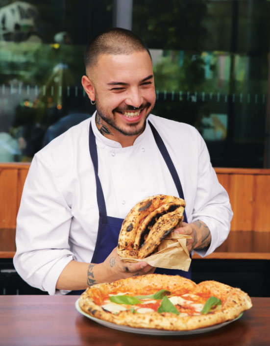 Andrea de Michele with a Pizza al portafoglio, as reproduced in Big Mamma