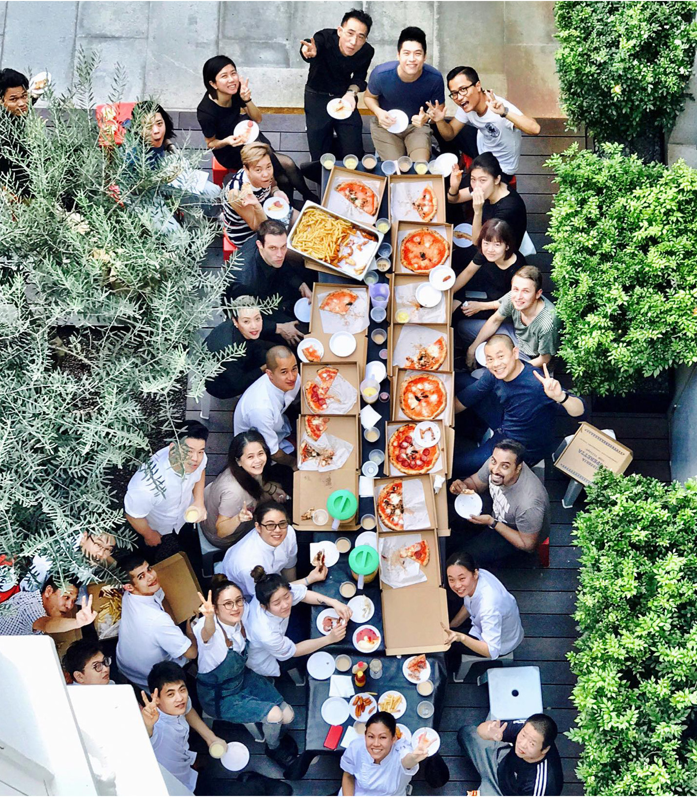 André Chiang (right side of the table, in the middle) and his Restaurant André brigade enjoy a rather un-Michelin pizza party. Image courtesy of Restaurant André