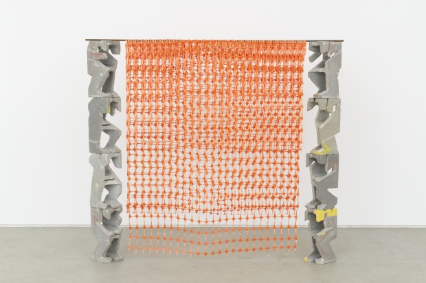 Allyson Vieira, Bearing Walls I, 2014. Concrete block, paint, epoxy, steel, barrier fence. Courtesy of the artist and Laurel Gitlen, New York