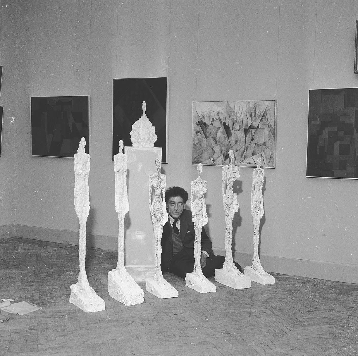 Alberto Giacometti and his sculptures at the Venice Biennale, 1956. Archives of the Giacometti Foundation. Image courtesy of Tate