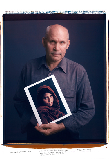 Steve McCurry with his Afghan Girl picture. Photograph by Tim Mantoani.
