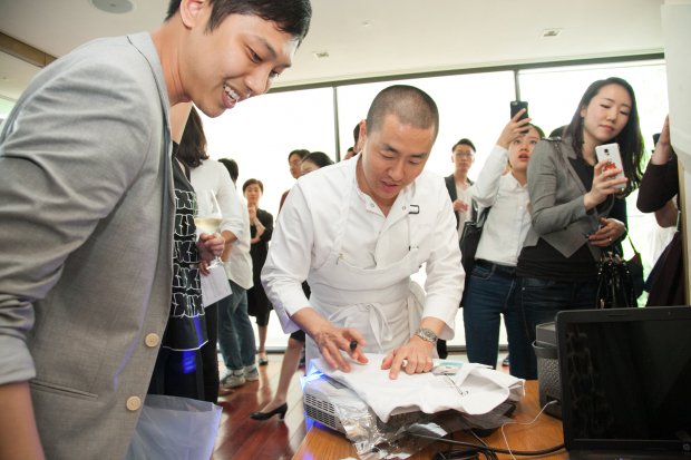 Corey Lee signing books at Bicena in Seoul. Photo by Seung Jung Lee