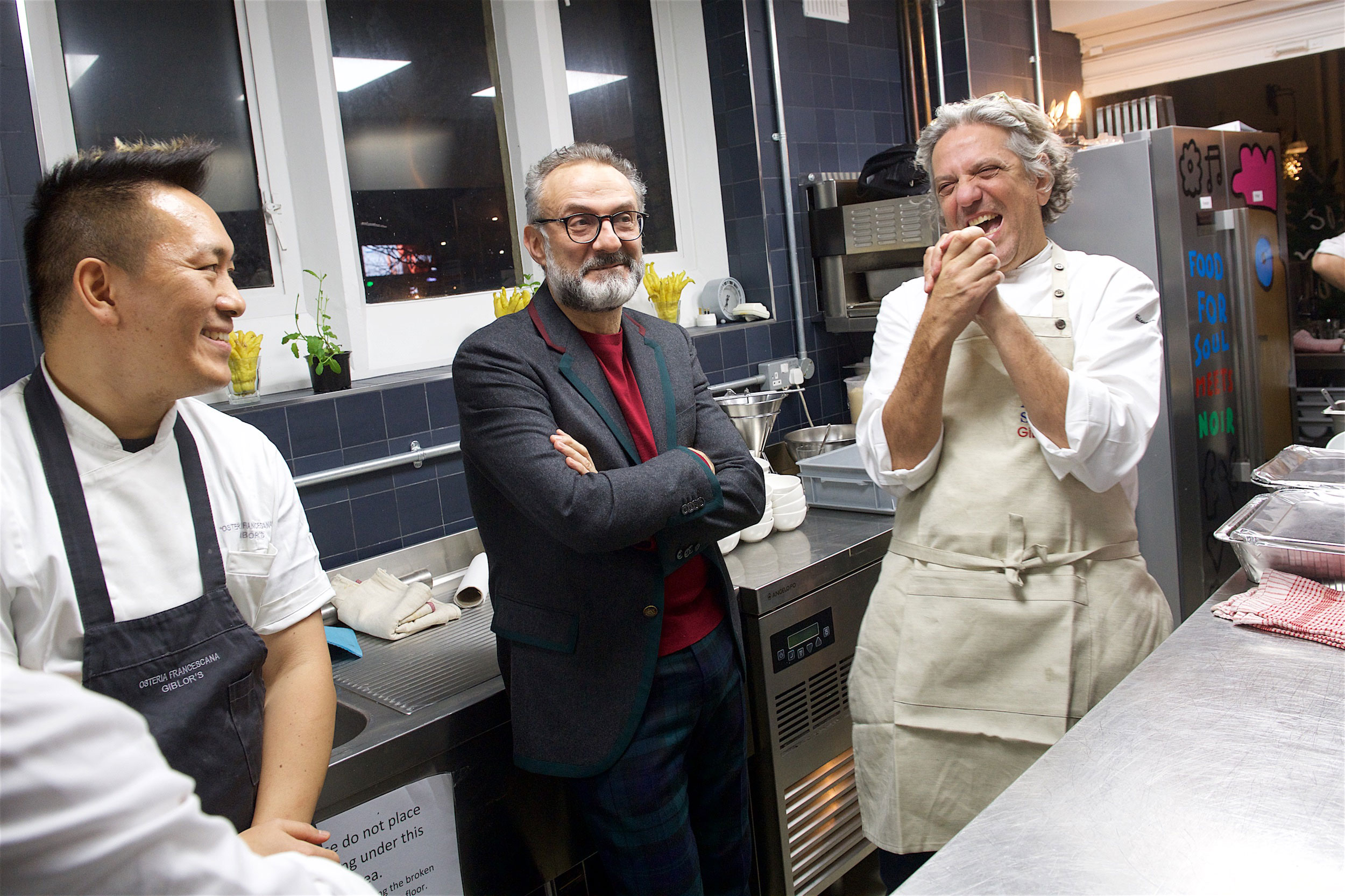 Taka, Massimo and Giorgio share a laugh in the kitchen before the event