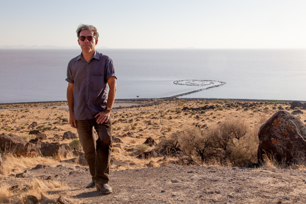 Bob Nickas beside Robert Smithson's Spiral Jetty, Utah. Photograph by Jason Metcalf