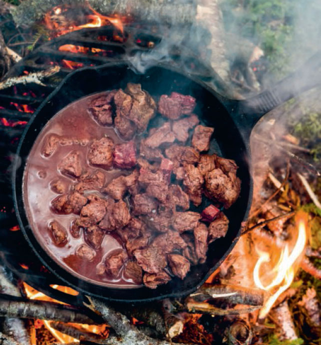 Bottled Moose cooking over an open fire, as featured in Wildness