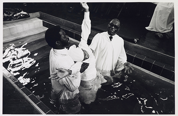Baptism from Handsworth from Inside series, 1968-1982 by Vanley Burke. From At Home with Vanley Burke, Ikon Gallery, Birmingham, 22 July – 27 September 2015, ikon-gallery.org. Courtesy Vanley Burke and Ikon