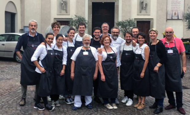 René Redzepi and Bottura with the staff at Refettorio Ambrosiano. Image courtesy of Bottura's Instagram