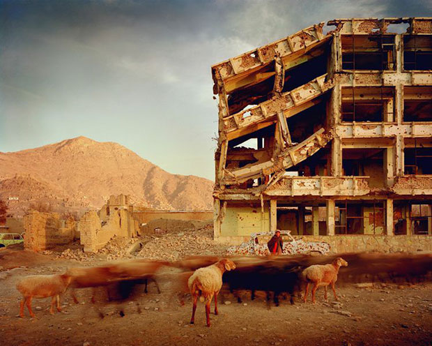 Simon Norfolk Bullet-scarred apartment building and shops in the Karte Char district of Kabul. This area saw fighting between Hikmetyar and Rabbani and then between Rabbani and the Hazaras 2003 © Simon Norfolk