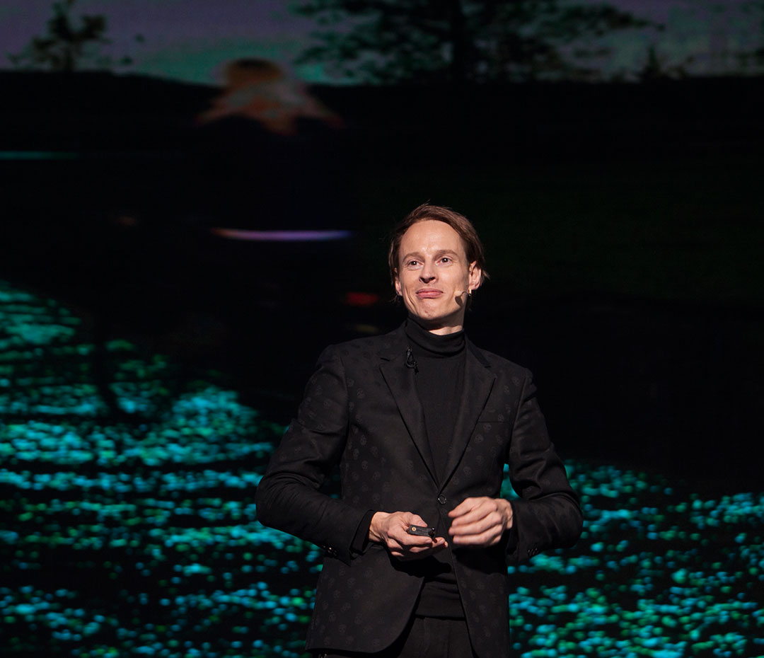 Daan Roosegaarde beside an image of his Van Gogh Bike Lane