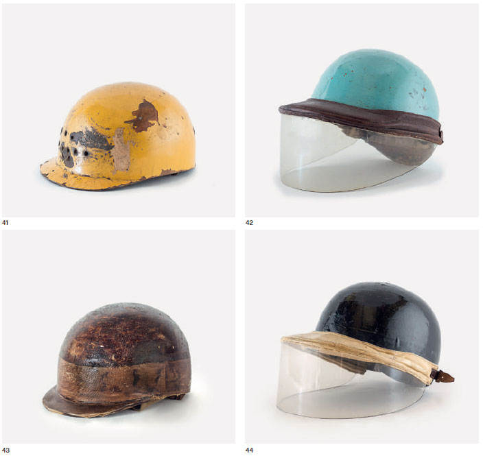 Clockwise from top left: José Froilán González's helmet; Alberto Ascari’s helmet; Mike Hawthorn's helmet; Juan Manuel Fangio's helmet.