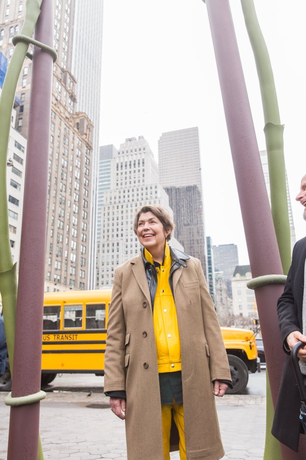 Isa Genzken at the feet of her Two Orchids. Image courtesy of Public Art Fund