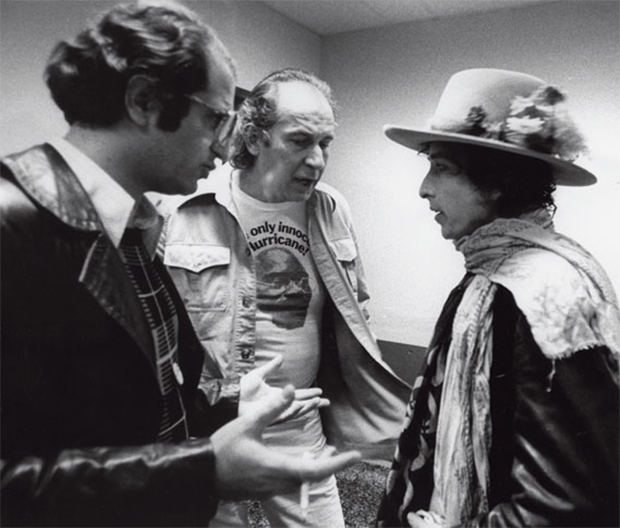 George (centre, in a Hurricane campaign t-shirt) and co-organiser Paul Sapounakis talk Bob Dylan into writing the protest song, Hurricane (1975)

