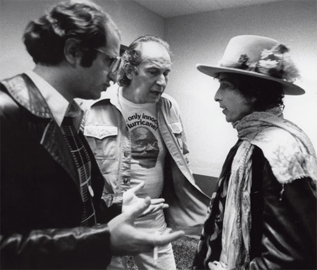 George (centre, in a Hurricane campaign t-shirt) and co-organiser Paul Sapounakis talk Bob Dylan into writing the protest song, Hurricane (1975)
