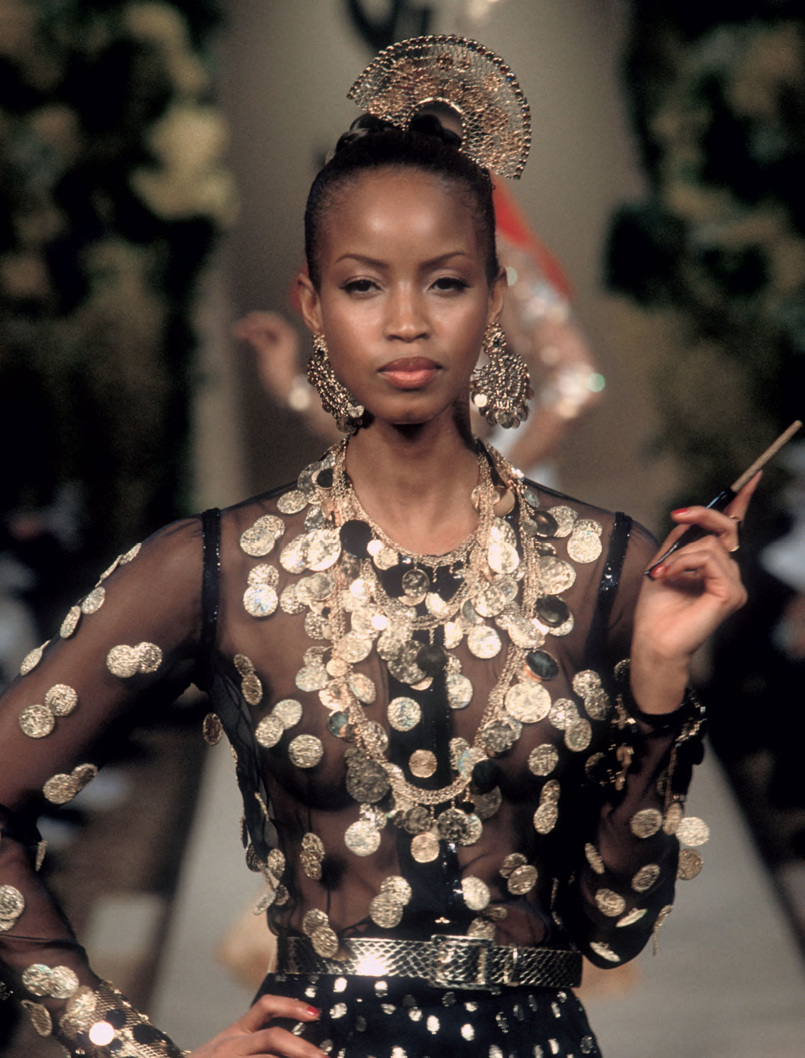 Gypsy-inspired dress with accessories, Spring/Summer 2000 haute couture collection. The model’s cigarette does not feature on the workshop sheet, but captures the mood Yves Saint Laurent was looking for