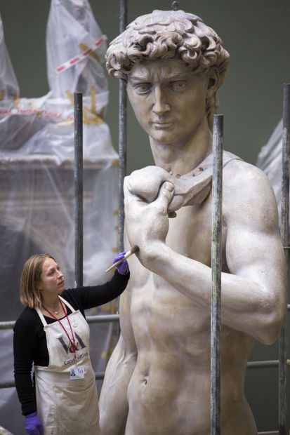 Conservator Johanna Puisto dusts the cast of Michelangelo's David post conservation, Nov 2014 in the Weston Cast Court