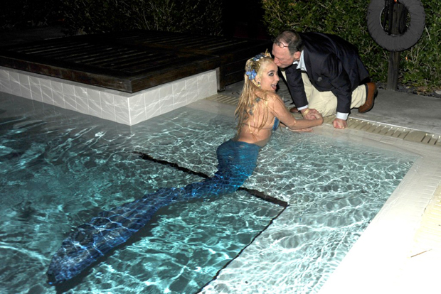 Anthony Haden-Guest kissing a mermaid at Art Basel Miami Beach, December 2009